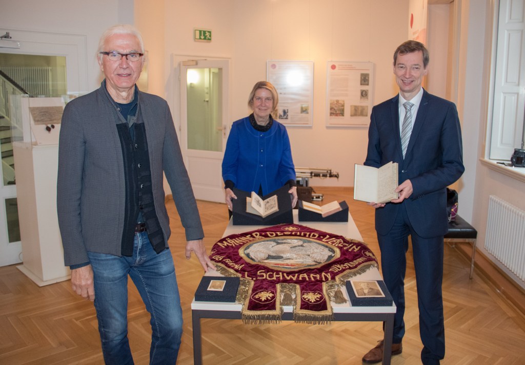 Georg Böhringer, Claudia Chehab und Stadtarchivleiter Dr. Jens Metzdorf vor den Leihgaben des Stadtarchivs Neuss.